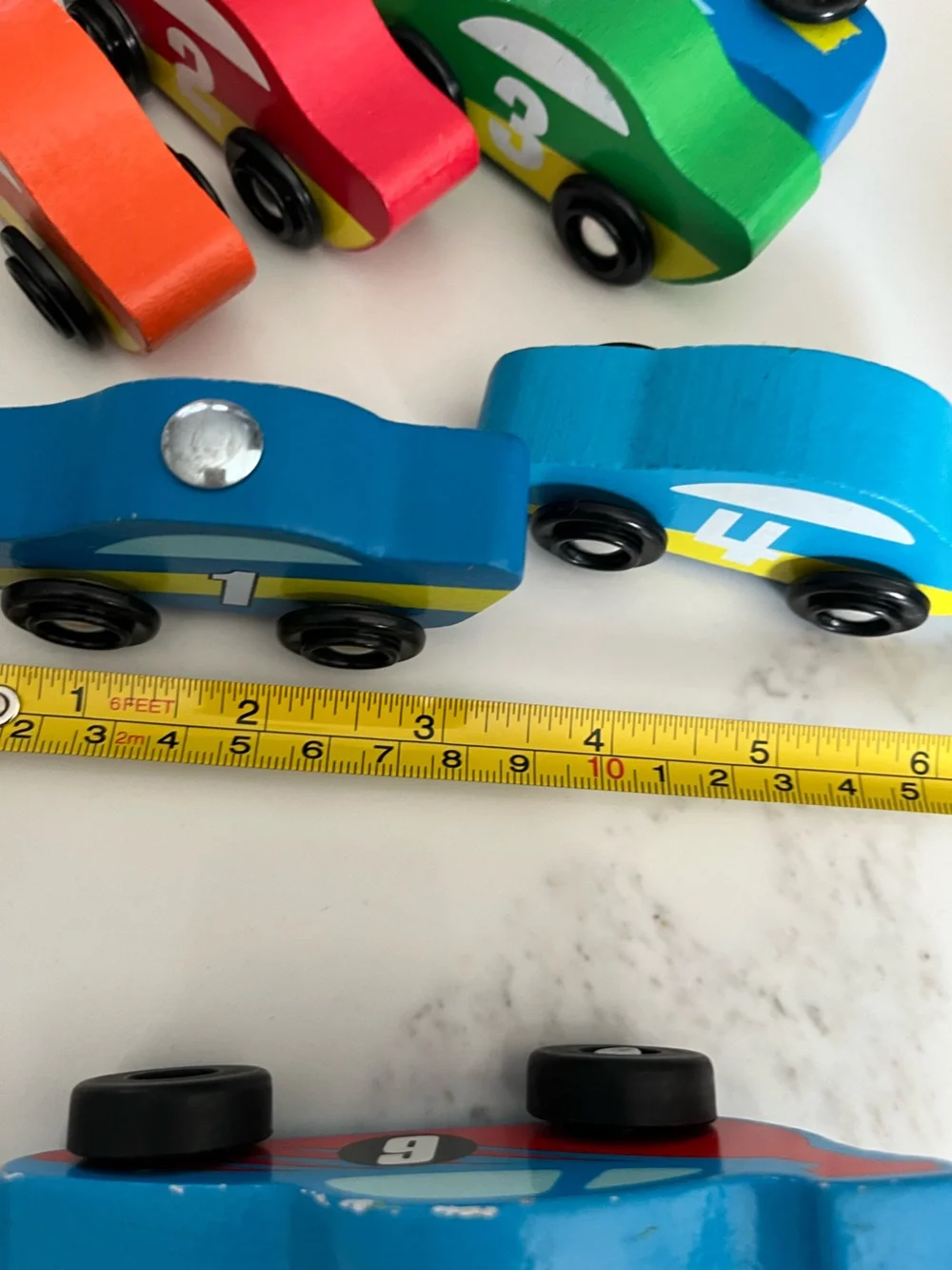8 wooden racing cars.   Cars Number 1-4 are Melissa & Doug.